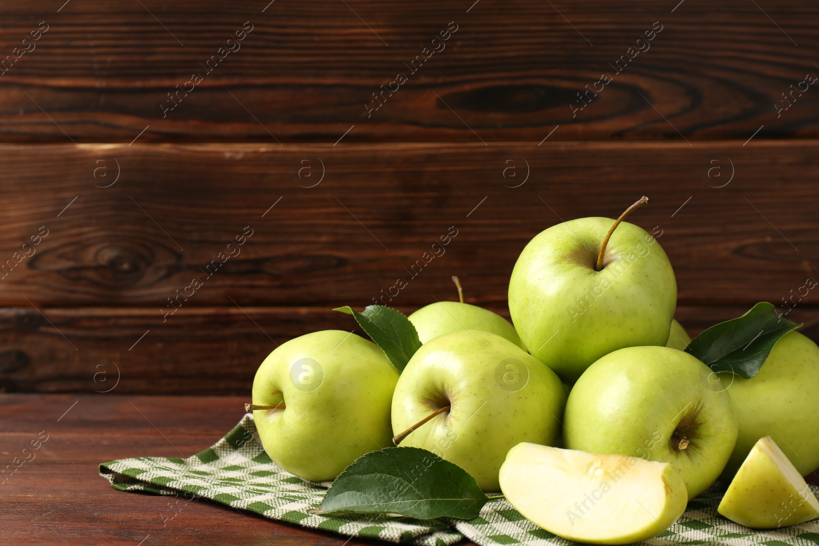 Photo of Fresh green apples on wooden table, space for text