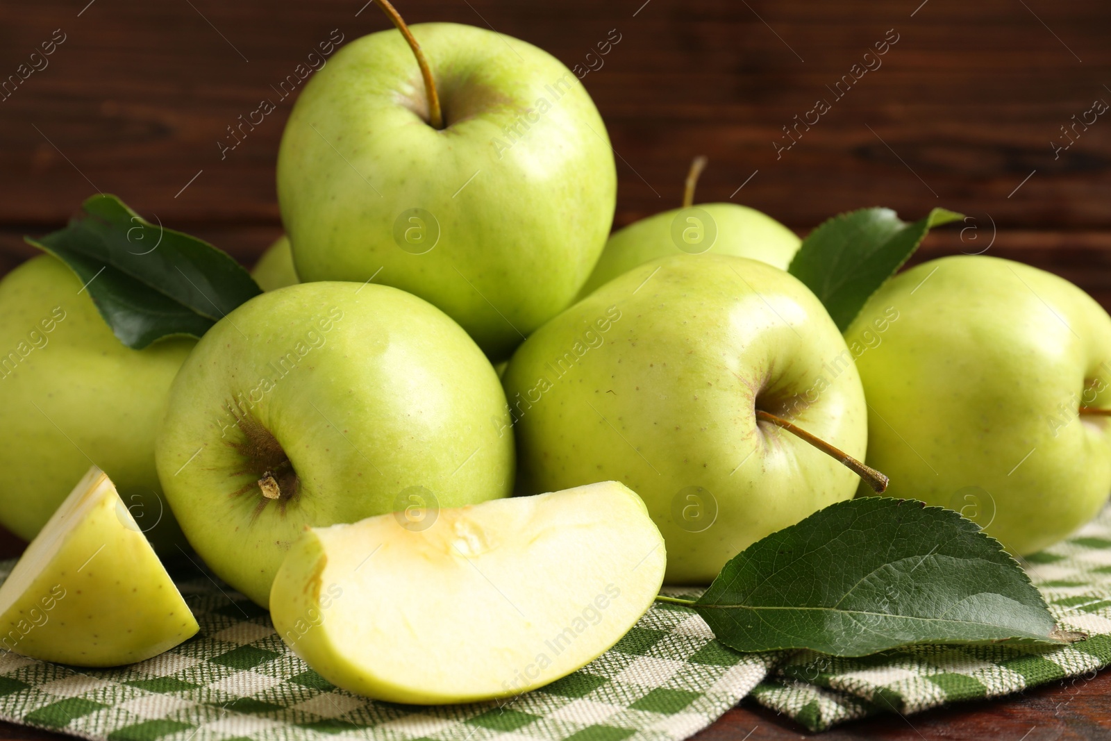 Photo of Fresh green apples on wooden table, closeup