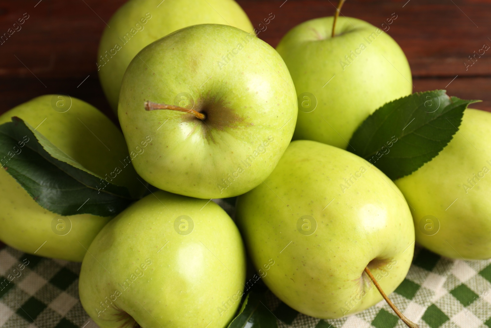 Photo of Fresh green apples on wooden table, closeup