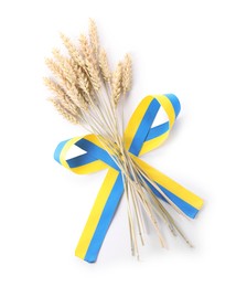 Photo of Ears of wheat with ribbon in colors of Ukrainian national flag isolated on white, top view