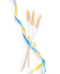 Photo of Ears of wheat with ribbons in colors of Ukrainian national flag isolated on white, top view