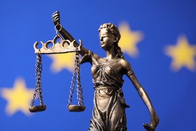 Figure of Lady Justice against European Union flag