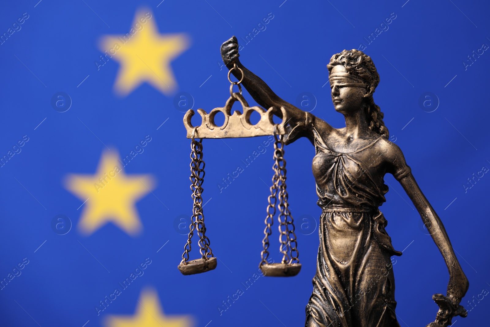 Photo of Figure of Lady Justice against European Union flag