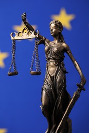 Photo of Figure of Lady Justice against European Union flag