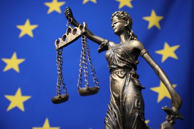 Photo of Figure of Lady Justice against European Union flag