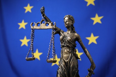 Figure of Lady Justice against European Union flag