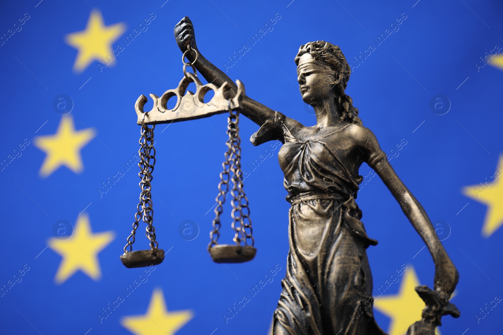 Photo of Figure of Lady Justice against European Union flag