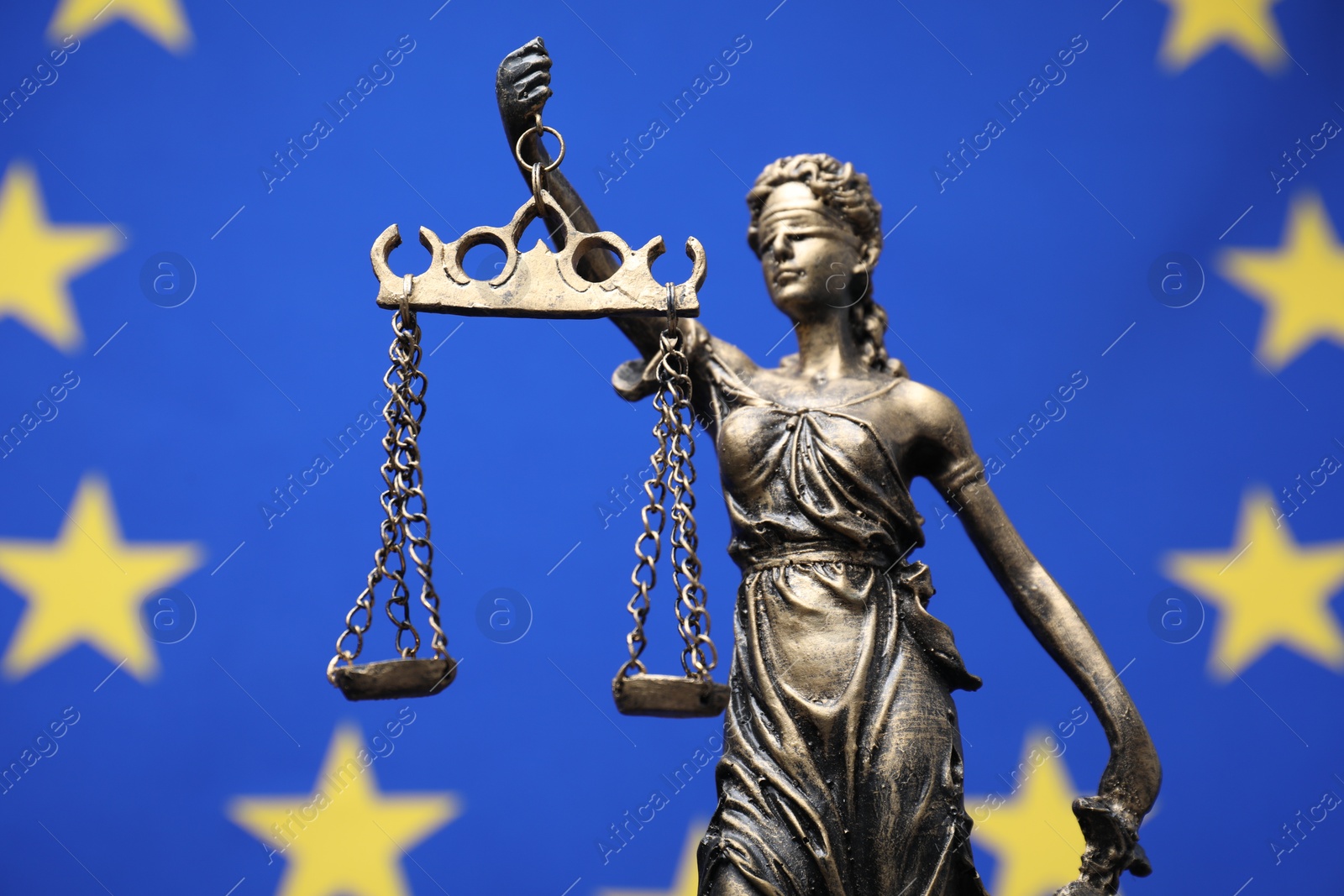 Photo of Figure of Lady Justice against European Union flag