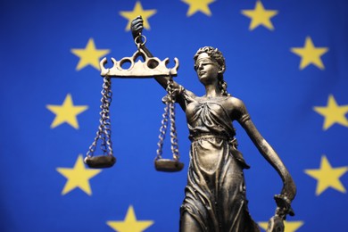 Photo of Figure of Lady Justice against European Union flag