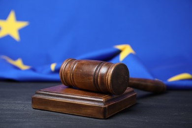 Judge's gavel on grey table against European Union flag