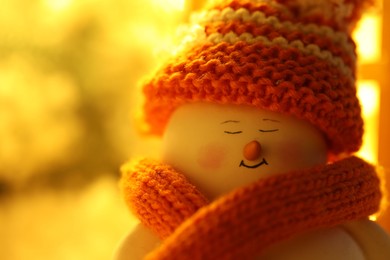 Photo of Cute decorative snowman against blurred background, closeup