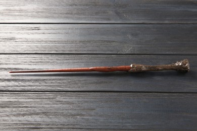 Photo of One old magic wand on wooden table