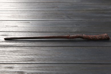 Photo of One old magic wand on wooden table