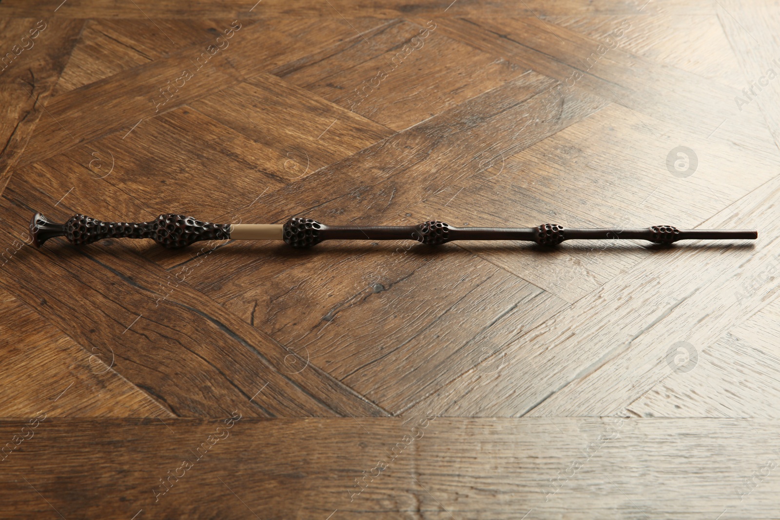 Photo of One old magic wand on wooden table