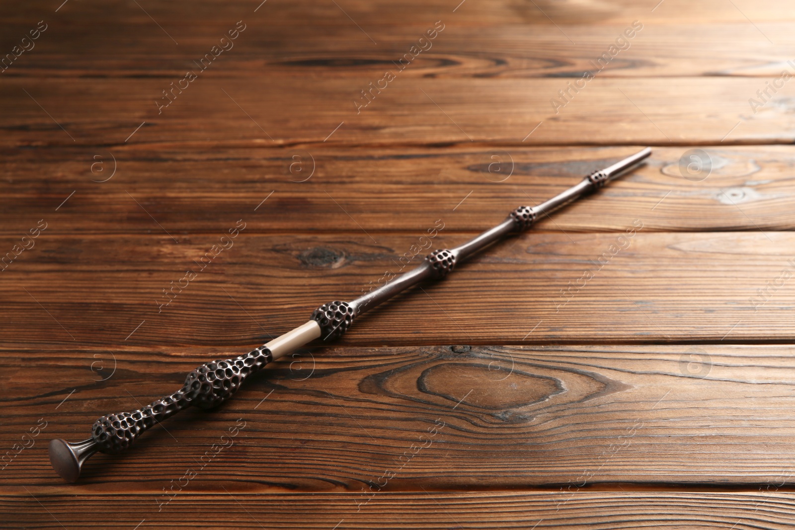 Photo of One old magic wand on wooden table