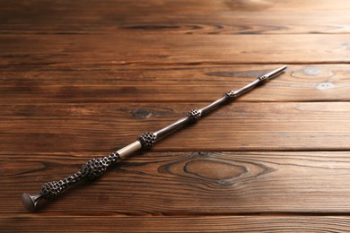 Photo of One old magic wand on wooden table