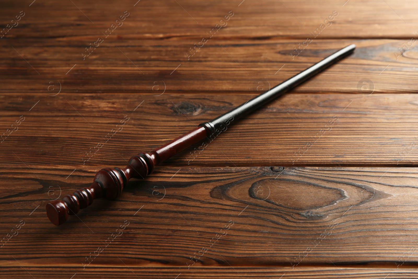 Photo of One old magic wand on wooden table