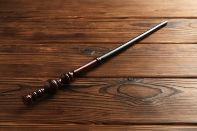 Photo of One old magic wand on wooden table