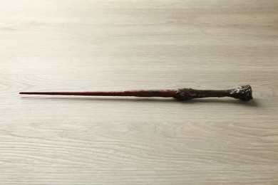 Photo of One magic wand on light wooden table