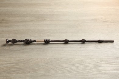 Photo of One magic wand on light wooden table