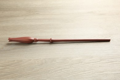 Photo of One magic wand on light wooden table