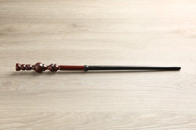 Photo of One magic wand on light wooden table