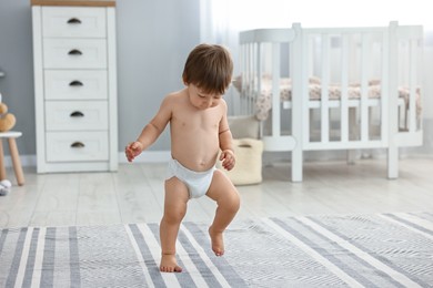 Photo of Cute little child in diaper at home