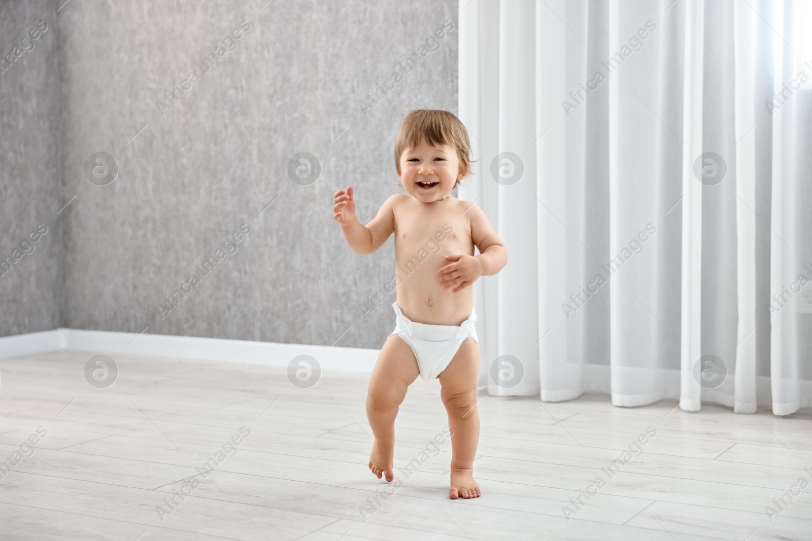 Photo of Cute little child in diaper at home