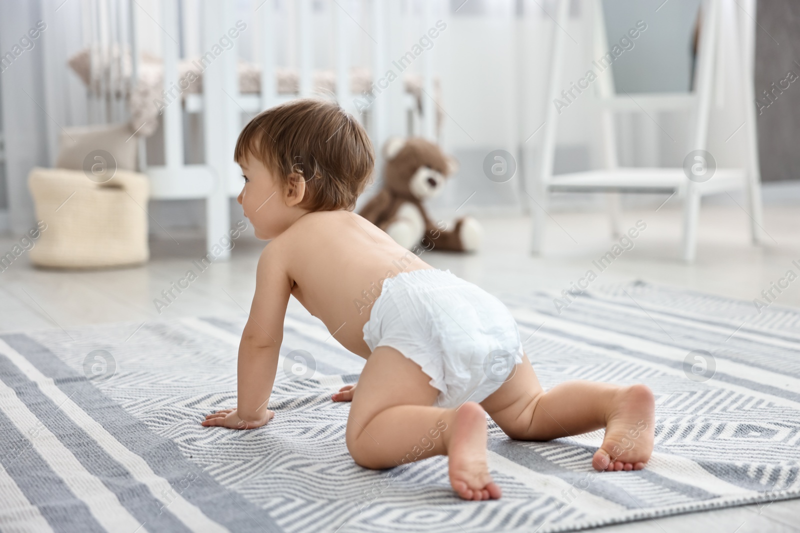 Photo of Cute little child in diaper at home