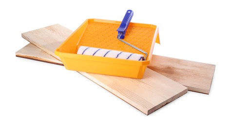 Wooden planks, roller and tray isolated on white. Building material and construction tools