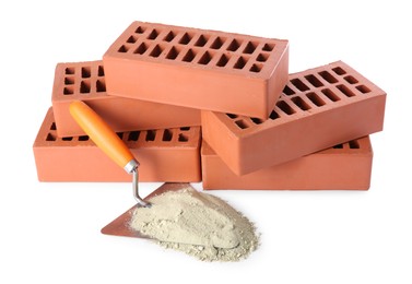 Photo of Trowel, cement powder and red bricks isolated on white. Building materials