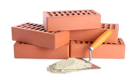 Photo of Trowel, cement powder and red bricks isolated on white. Building materials