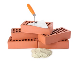 Trowel, cement powder and red bricks isolated on white. Building materials