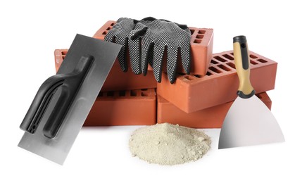 Photo of Putty knives, cement powder, gloves and red bricks isolated on white. Building materials and construction tools