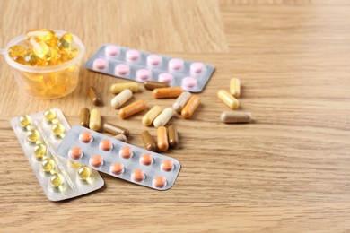 Photo of Pharmacist. Different pills on wooden table, space for text