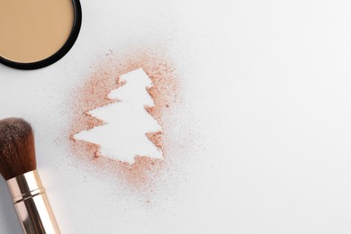 Christmas tree made of powder and makeup brush on white background, flat lay. Space for text