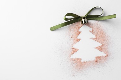 Christmas ball in shape of tree made of powder and bow on white background, top view. Space for text