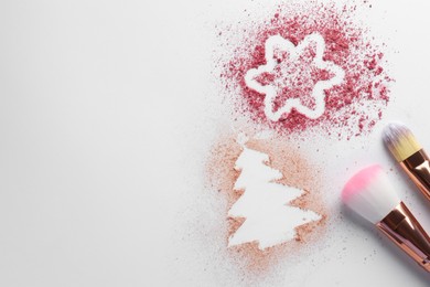 Photo of Christmas decorations made of powder and blush near makeup brushes on white background, flat lay. Space for text