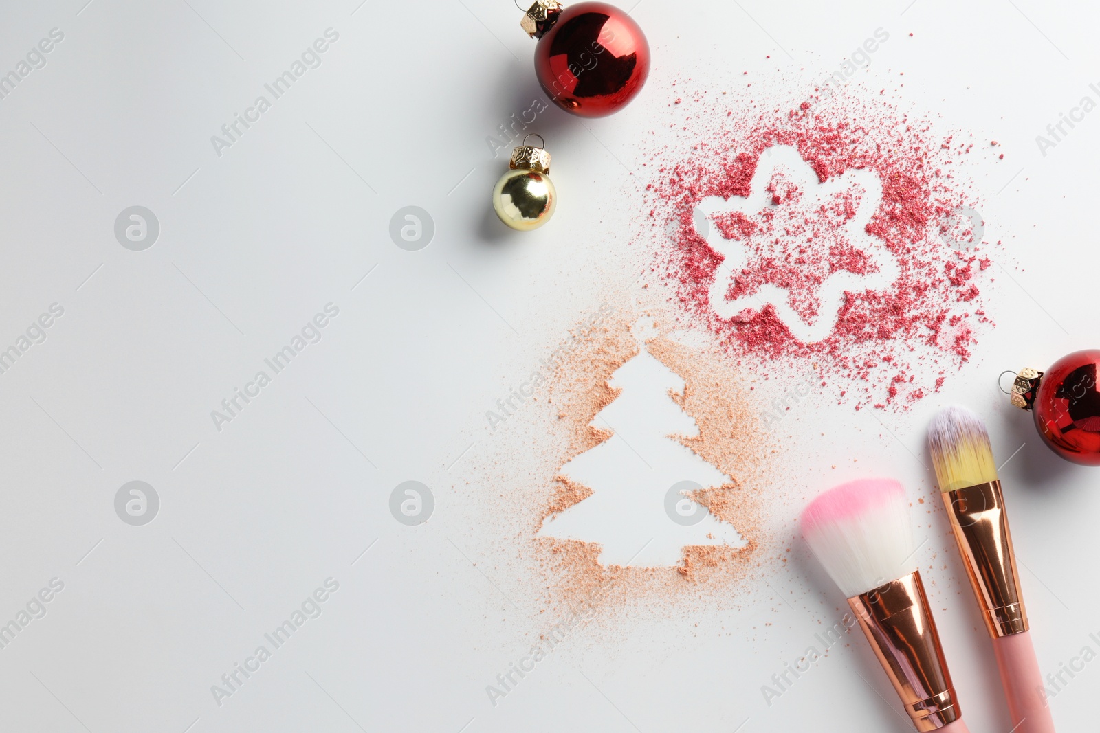 Photo of Christmas decorations made of powder and blush, balls and makeup brushes on white background, flat lay. Space for text