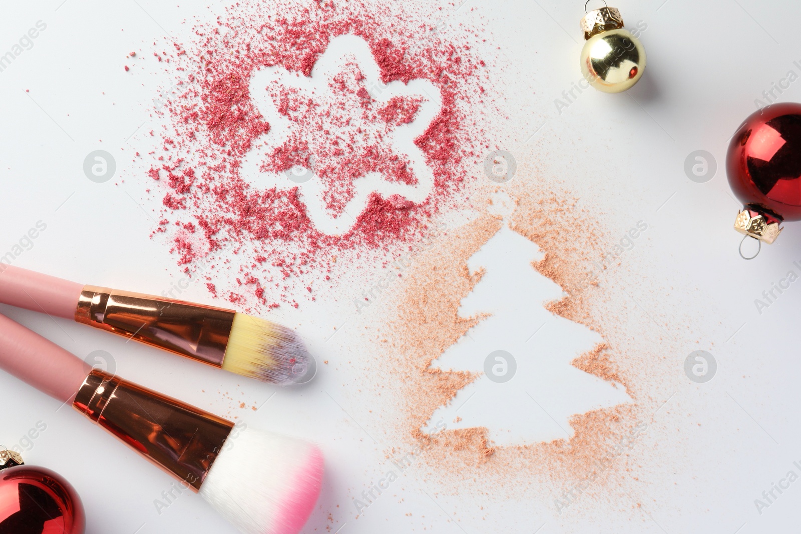 Photo of Christmas decorations made of powder and blush, makeup brushes and balls on white background, flat lay