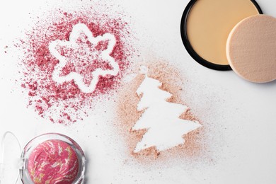 Christmas decorations made of powder and blush on white background, flat lay