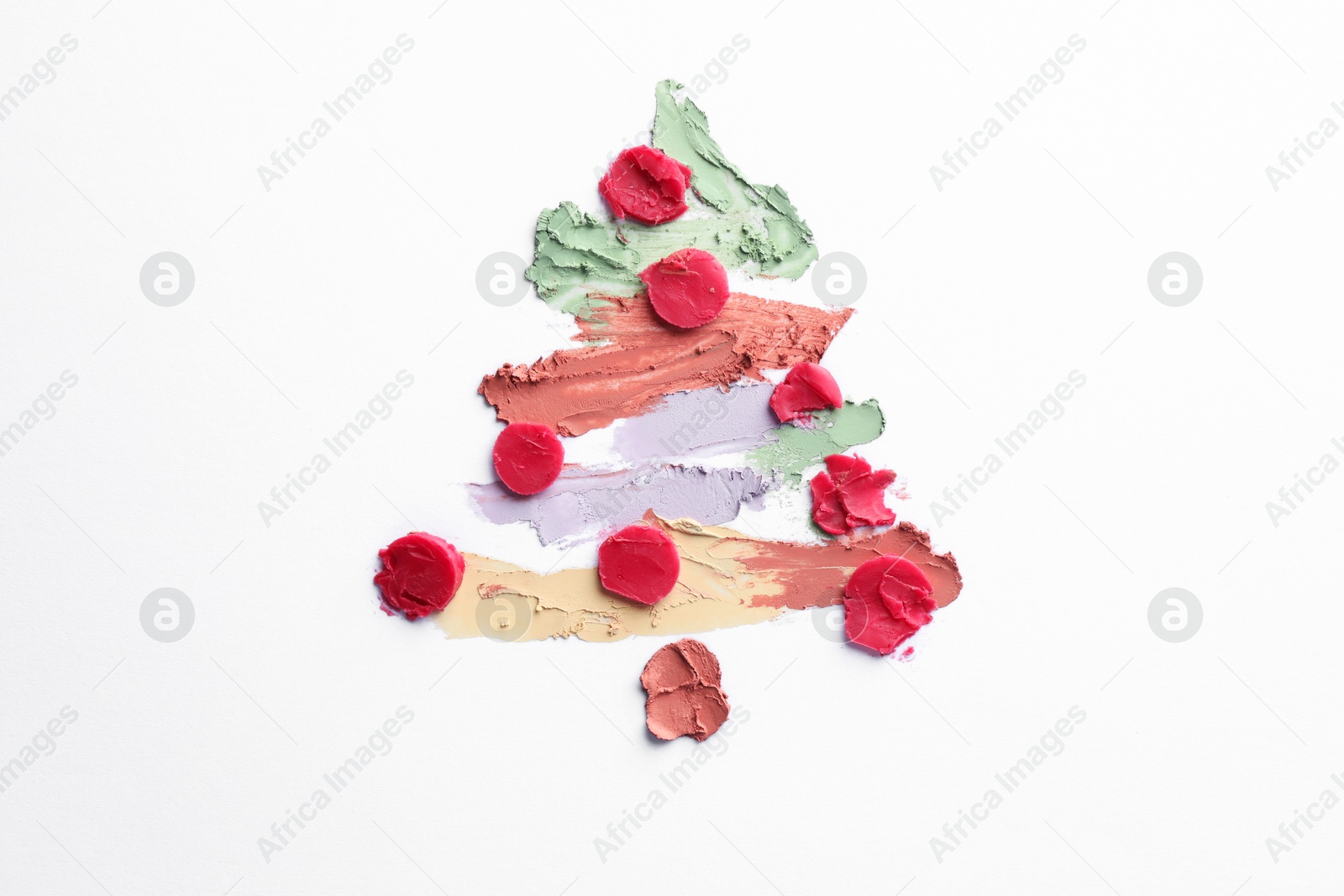 Photo of Christmas tree drawn with concealers on white background, top view