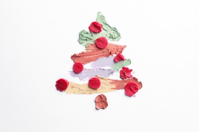 Photo of Christmas tree drawn with concealers on white background, top view