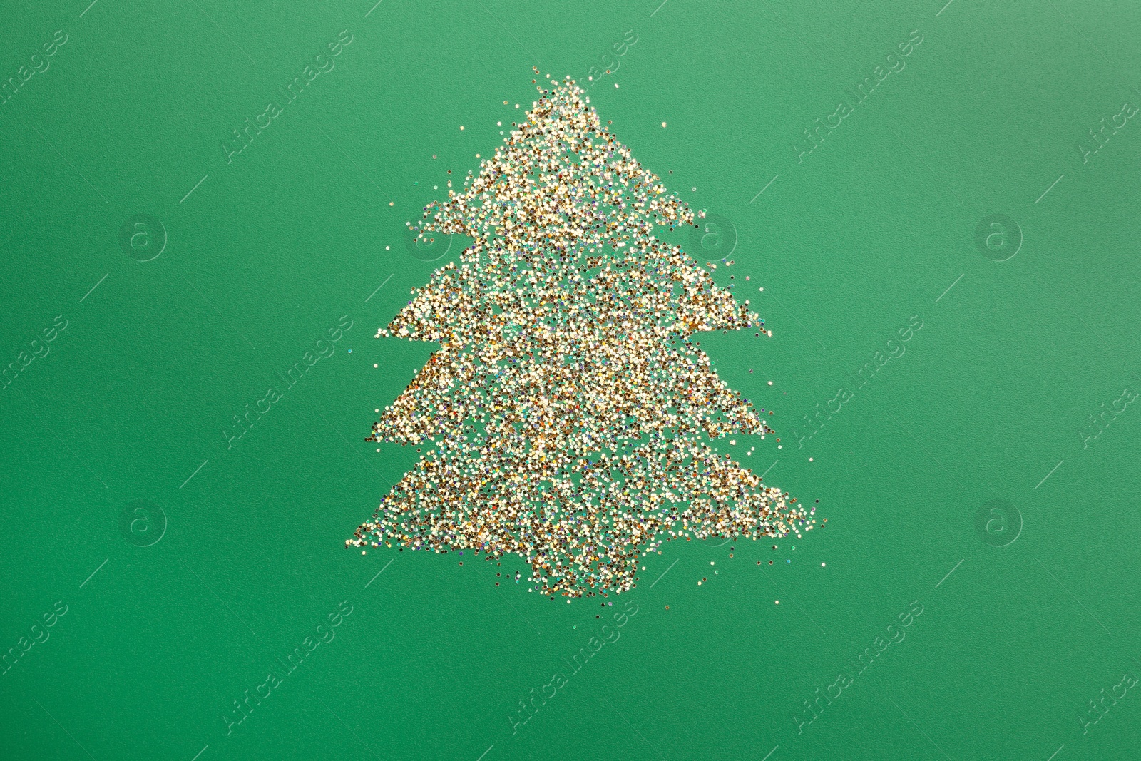 Photo of Christmas tree made of glitter on green background, top view