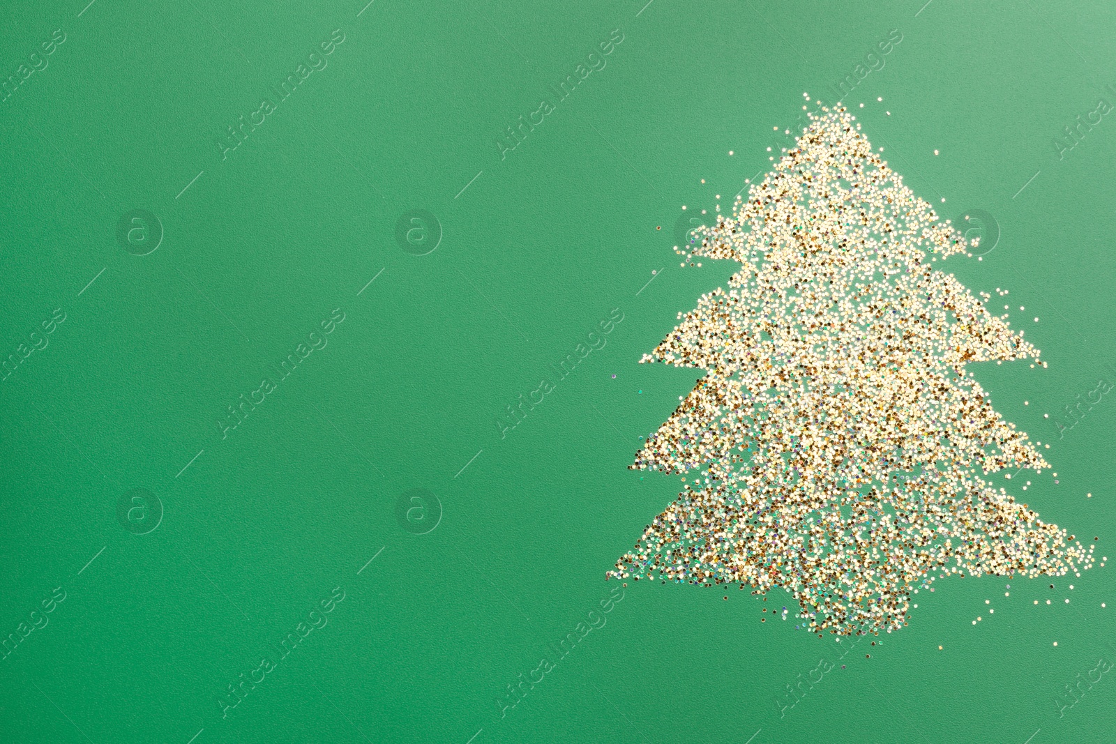 Photo of Christmas tree made of glitter on green background, top view. Space for text