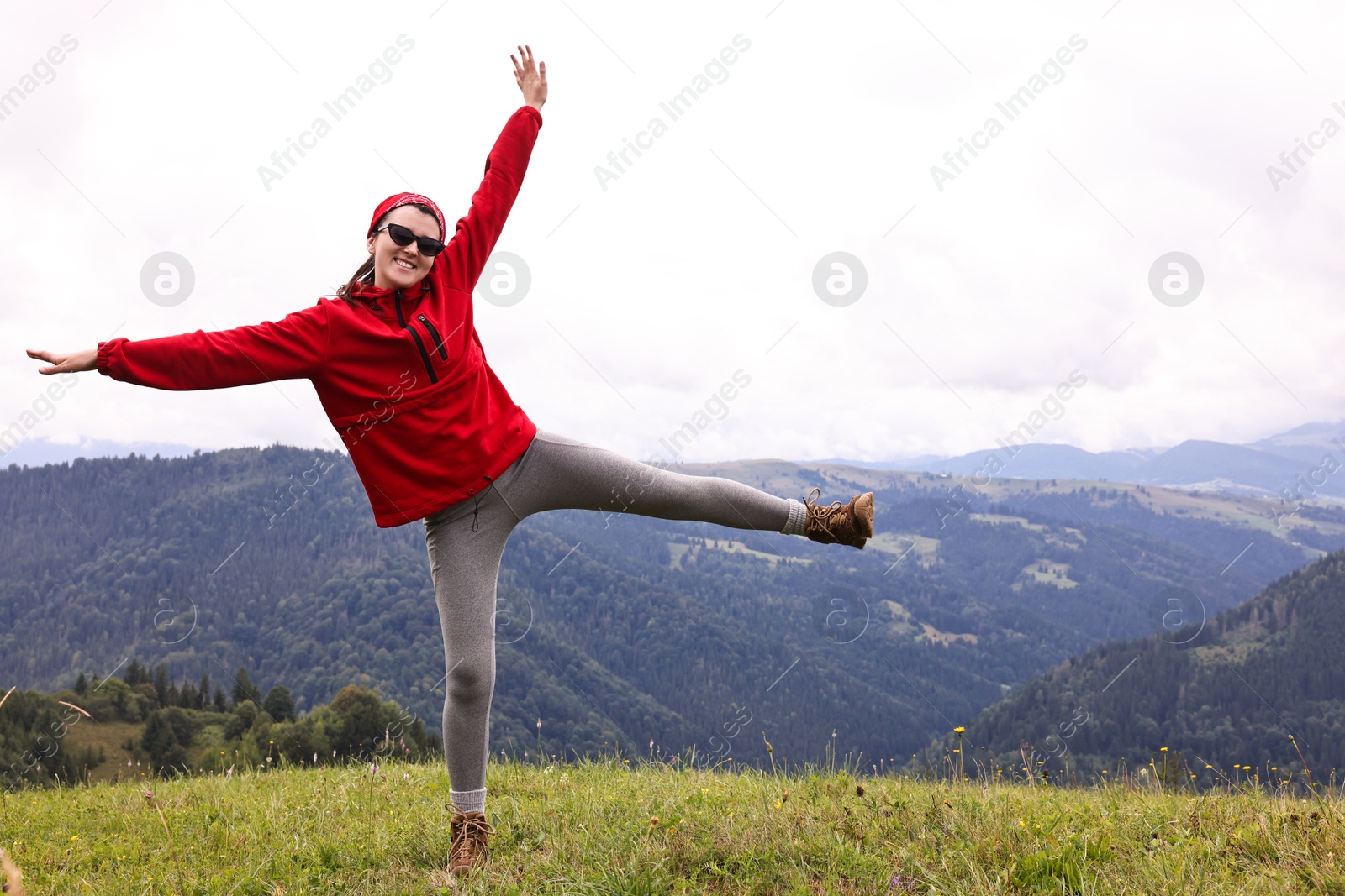 Photo of Happy young hiker in mountains. Active tourism