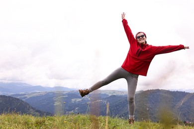 Happy young hiker in mountains. Active tourism