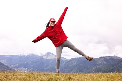 Photo of Happy young hiker in mountains. Active tourism