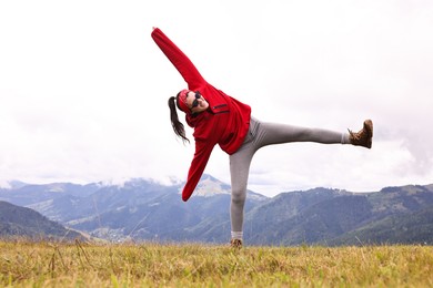 Photo of Happy young hiker in mountains. Active tourism