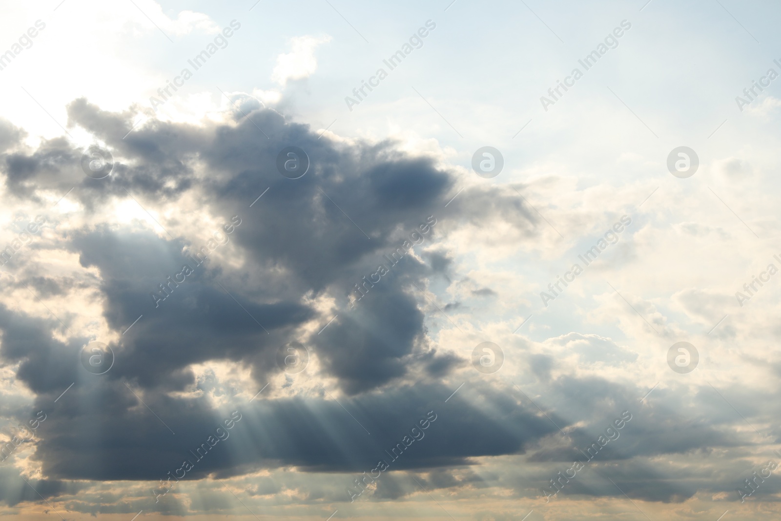 Photo of Sun shining through clouds on beautiful sky